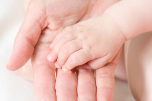 caucasian baby hand in father's palm